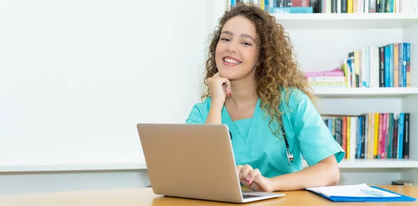 Pretty medical student or female nurse at work at hospital with copy space