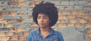 Sad african american young adult woman outdoor in city
