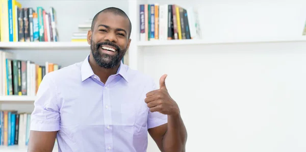 Successful african american businessman with beard indoors at office