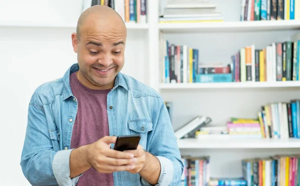 Laughing Bald Man Sending Message Mobile Phone Indoors Home — Photo