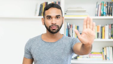 Sakallı İspanyol hippi adam ofiste durur.