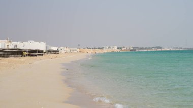 Multiple tents in the Qatar Fuwairit beach setup for camping during the winter beginning season.