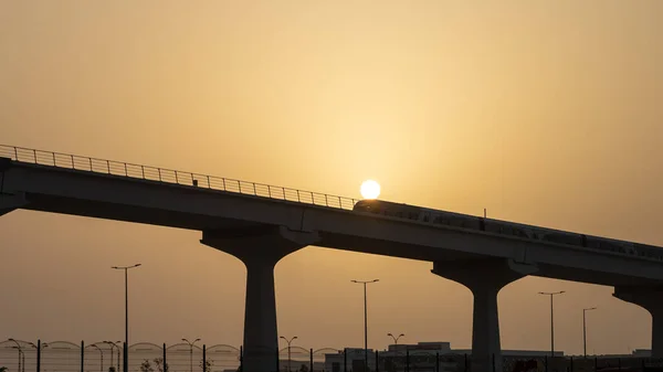 Doha, Qatar- June 06,2022 :Qatar red line metro traveling through the bridge.