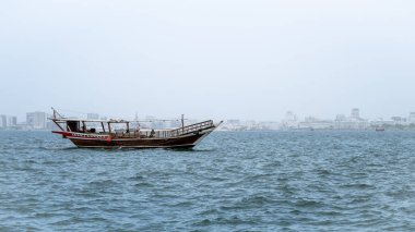 people riding on the traditional Dhow boats in qatar corniche.