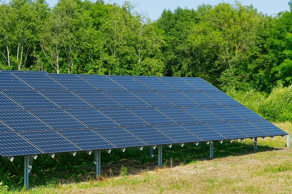 Solar power plant in summer day. Photovoltaic panels for renewable electric production.