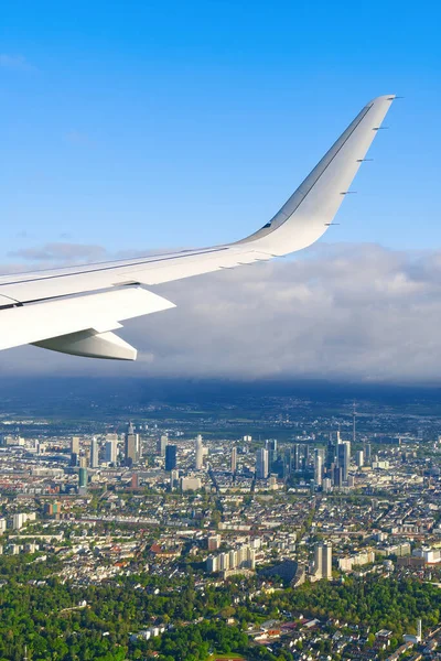 Pohled na letadlo bílé křídlo létající na modré obloze nad mraky. — Stock fotografie