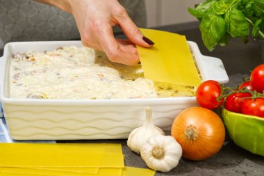 Kadın mutfakta lazanya hazırlıyor. Lazanya tarifi - İtalyan yemeği