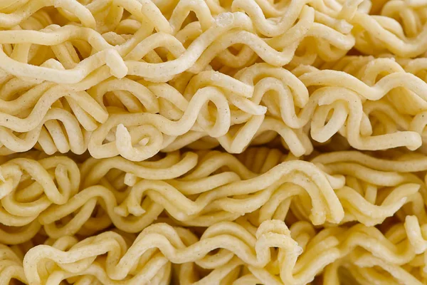 Fideos instantáneos crudos. Cerrar textura de fideos instantáneos para el fondo. —  Fotos de Stock