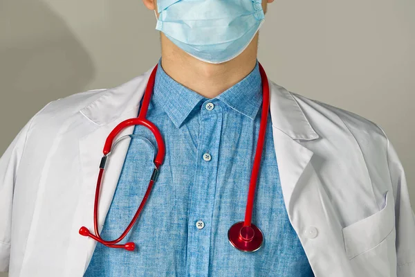 Unrecognizable young man doctor standing over light background — Stock Photo, Image