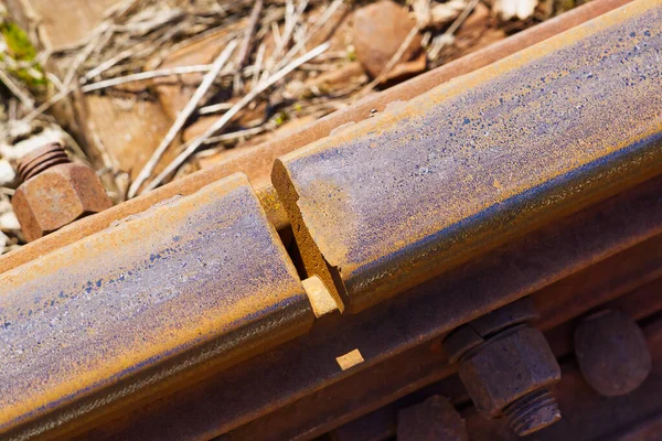 İki rayı birbirine bağlıyorum. Altında tren rayları, raylar ve ezilmiş taşlar Fishplaka 'daki raylar arasındaki boşluk