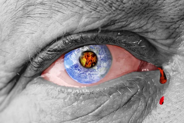 The earth globe inside of a mans eye. the concept of the destruction of the earth in the human eye. death of the planet due to an atomic explosion or nuclear strike