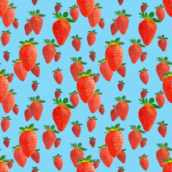 Fresh strawberry seamless pattern. Ripe strawberries isolated on blue. Package design background. Falling strawberry selective focus.