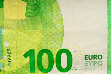 Fragment hundred Euro bill. 100 euro banknote close-up. The euro is the official currency of 19 out of the 27 member states of the European Union