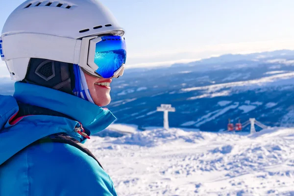 Happy woman in ski goggles against a ski-lift and wonderful winter mountains background.Smiling women in alps skiing in Italy, Austria, Sweeden