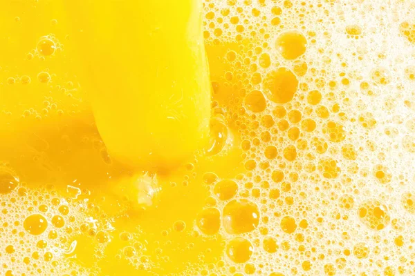 Closeup of splashing orange juice, top view. Splash of fresh sweet orange, mango, fruit juice. Freeze motion of pouring orange juice .