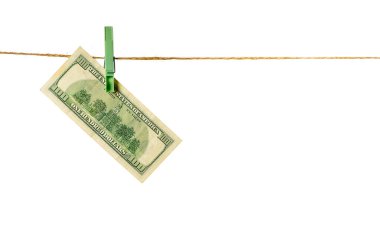 Money laundering. Dollar banknotes hanging on clothesline against white background. USD laundering concept.