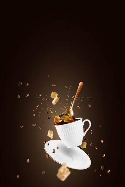 Falling coffee cup. Cup of coffee splashes while falling. Splash in white coffee cup. Hot beverage splashing, food levitation