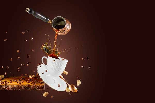 Falling coffee cup. Cup of coffee splashes while falling. Splash in white coffee cup. Hot beverage splashing, food levitation