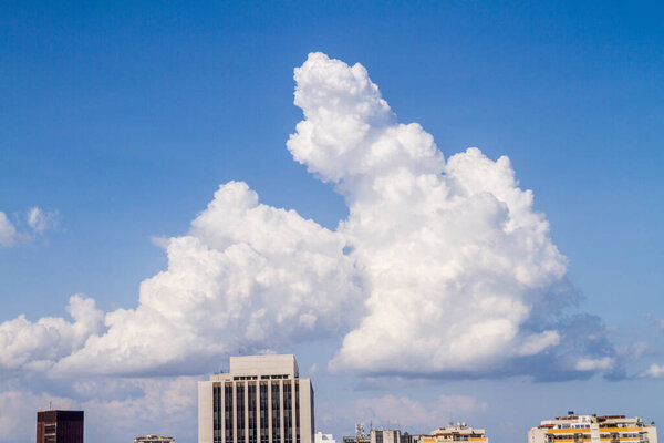 big cloud with a blue sky in the background in Rio de Janeiro, Brazil.
