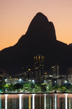 Sunset at Rodrigo de Freitas Lagoon with Two Hill Brother in the background in Rio de Janeiro, Brazil.