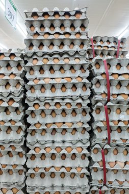 Stacked of eggs for wholesale at the market clipart