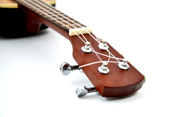 Närbild ukulele på vit bakgrund Stockbild
