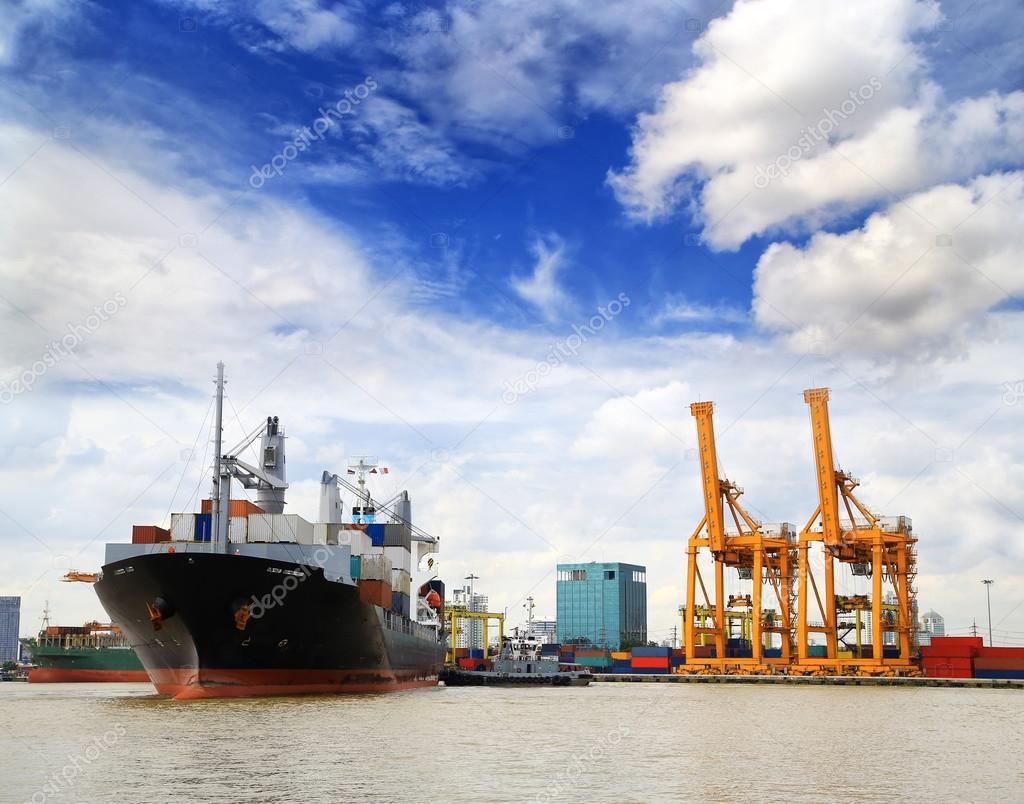 Cargo ship at the port outgoing with blue sky