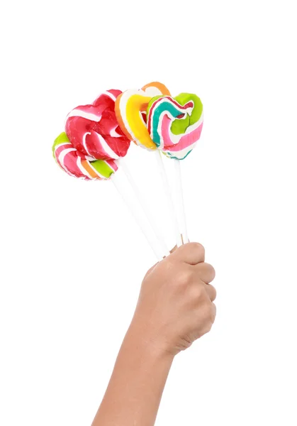 Bunte Lutscher auf Kinder Hand isoliert auf dem weißen — Stockfoto