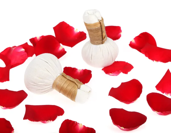 Herbal compress balls for spa treatment with red rose petals. — Stock Photo, Image