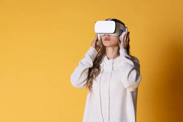 Interactive virtual reality goggles.Asian teen woman wearing VR or Virtual Reality head set for enter to the digital simulation world for learning and traveling or gaming and more.Digital technology for business and e-learning. Virtual distant study.