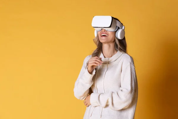 Interactive virtual reality goggles.Asian teen woman wearing VR or Virtual Reality head set for enter to the digital simulation world for learning and traveling or gaming and more.Digital technology for business and e-learning. Virtual distant study.
