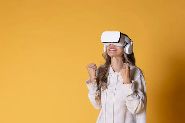 Interactive virtual reality goggles.Asian teen woman wearing VR or Virtual Reality head set for enter to the digital simulation world for learning and traveling or gaming and more.
