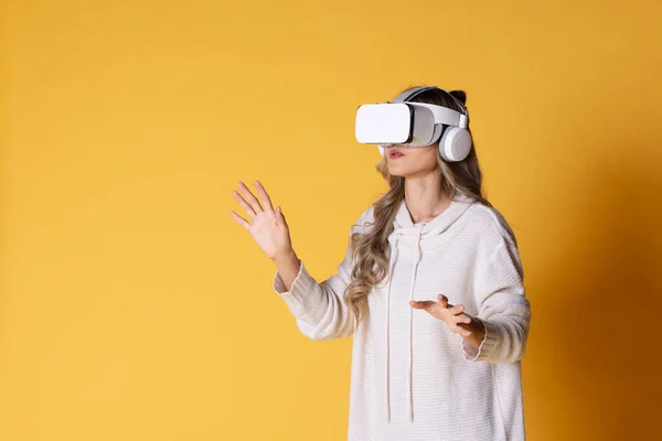 Interactive virtual reality goggles.Asian teen woman wearing VR or Virtual Reality head set for enter to the digital simulation world for learning and traveling or gaming and more.