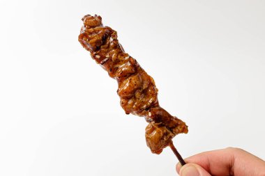 Teriyaki chicken skewers on a white background