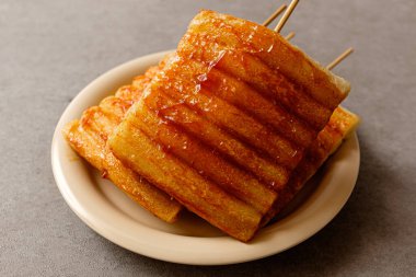 Fried rice cake skewers coated with red pepper paste seasoning