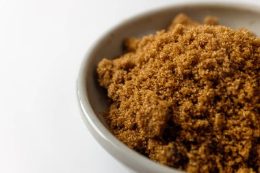 Dark brown sugar on a white background