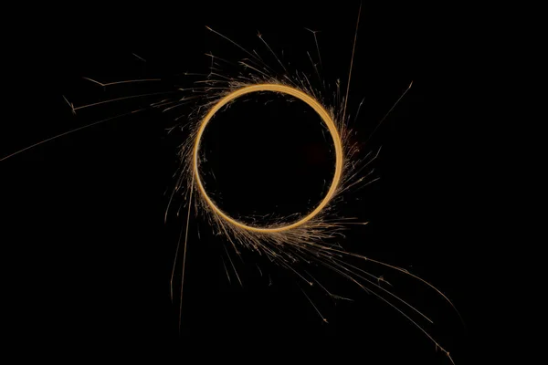 Circle with sparks on a black background — Stockfoto