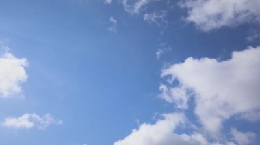 Mavi gökyüzü 4k videosunun arka planında beyaz kabarık bulutlar