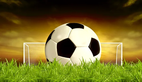 Bola de futebol no pôr do sol verde Fundo — Fotografia de Stock