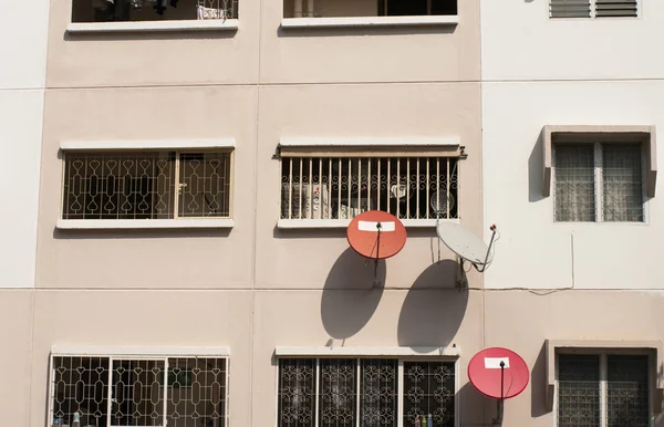 Satellite dishes on the residence apartment wall — Stock Photo, Image