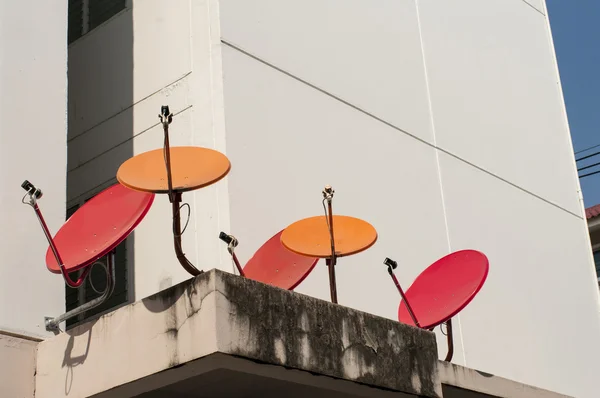 Red and orange satellite dishes — Stock Photo, Image