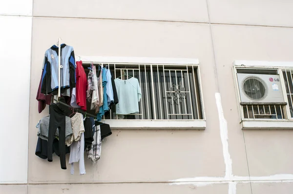 Cloth drying outside apartment window — Stock Photo, Image