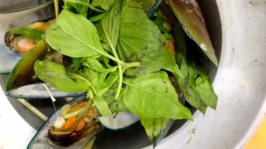 Thai food seafood mussel baked pot with basil eating together at local shop