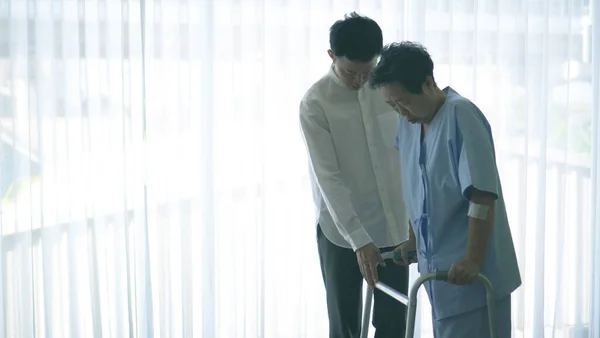 Asian Caring Loving Son Helping Old Injured Mother Physical Theraphy — Stock Fotó