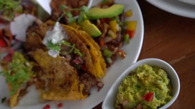 Mexican plates top view nacho beef salsa salad bean and avocado guacamole healthy food