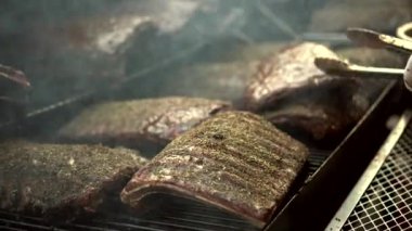 Grilling barbecue pork ribs marinated with herb and juciy sauce on flame charcoal American bbq party