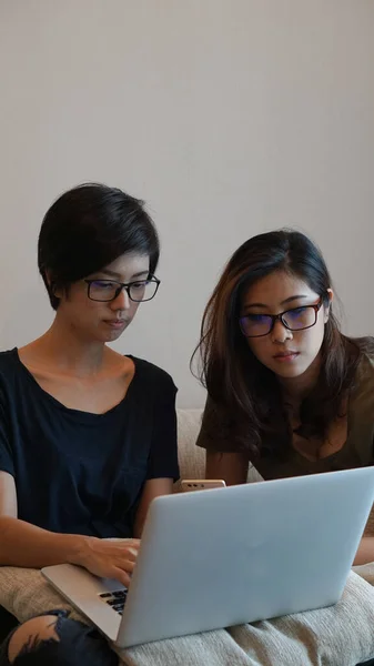 Two entrepreneur Asian woman glasses working from anywhere with laptop computer