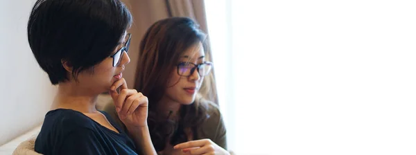 Two entrepreneur Asian woman glasses working from anywhere with laptop computer