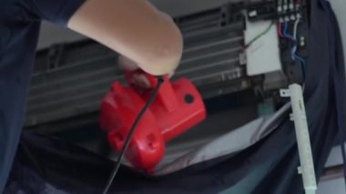 Techinician worker cleaning air conditioner blow dry after wash