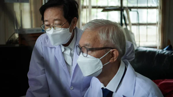 Two Asian Senior Doctor Health Care Technician Looking Patient Information —  Fotos de Stock